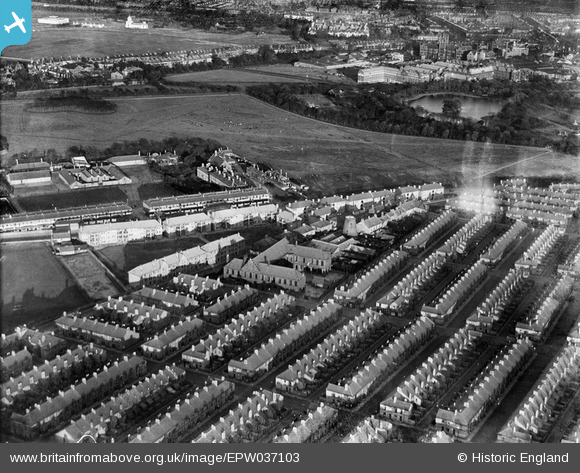 Aerial photograph looking east taken in 1931 showing Darnell Street, Newcastle-upon-Tyne. To the upper left are the artillery barracks. The building in the centre is Todds Nook school (closed 1983). Darnell street runs from left to right just in front of the school. The lake to the upper right is now called Leazes Park Lake.